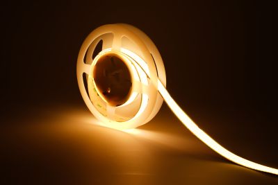 COB LED Streifen 24V mit 960 LEDs/m und 15 mm Breite in warmweißer Beleuchtung – auf Rolle mit abgewickeltem Abschnitt, homogenes und punktfreies Licht für hochwertige Innenbeleuchtung